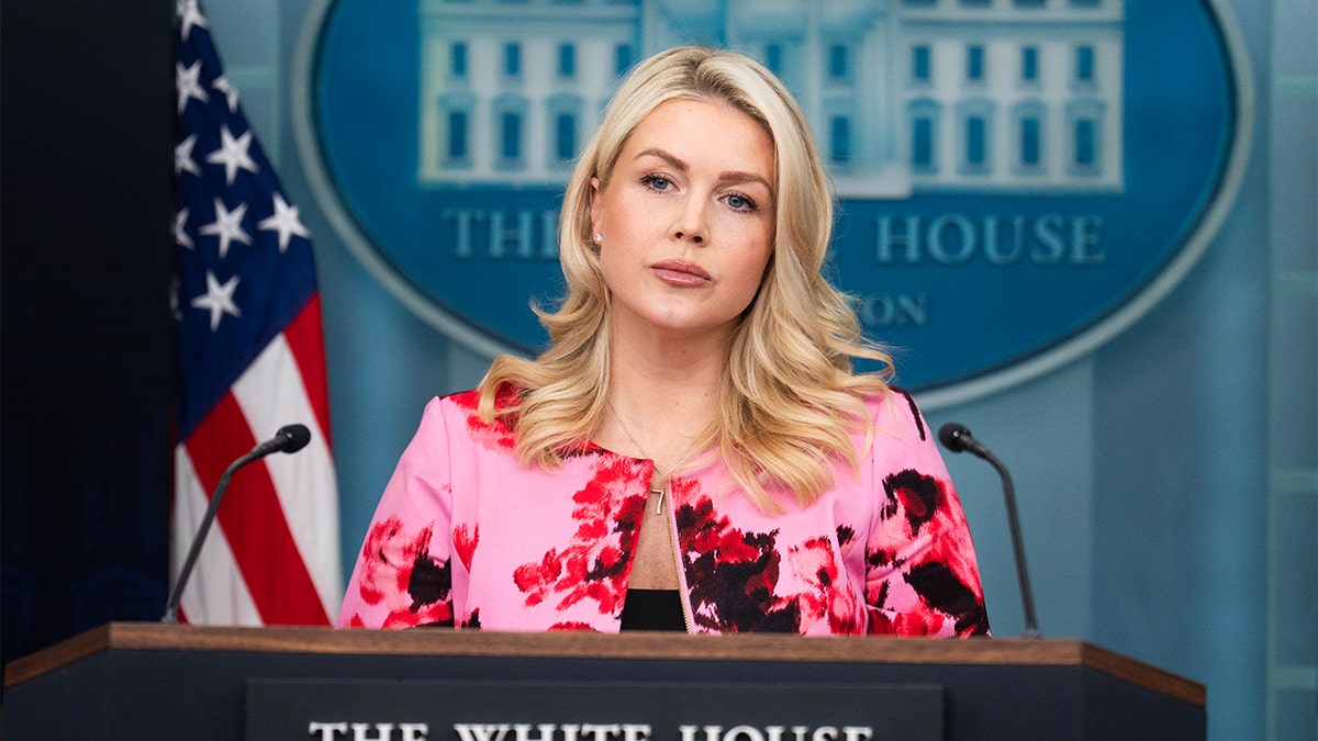 Karoline Leavitt speaking at a White House press briefing podium.